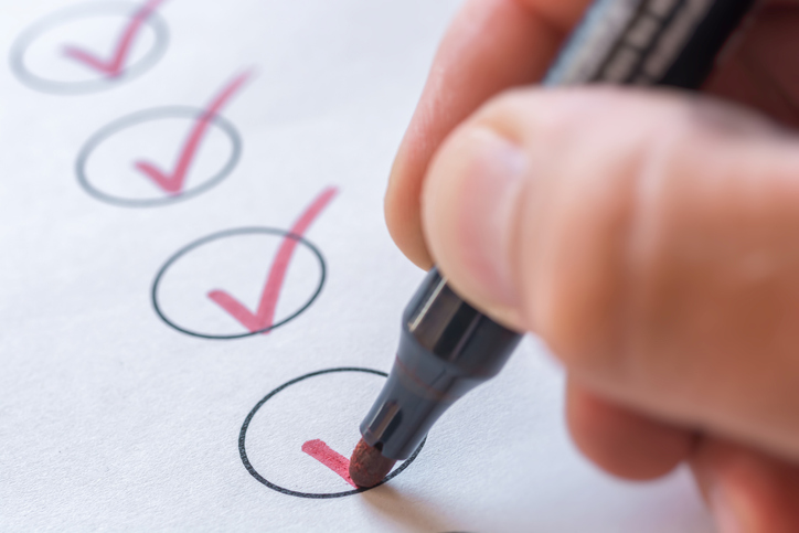 Close up of a pen checking boxes